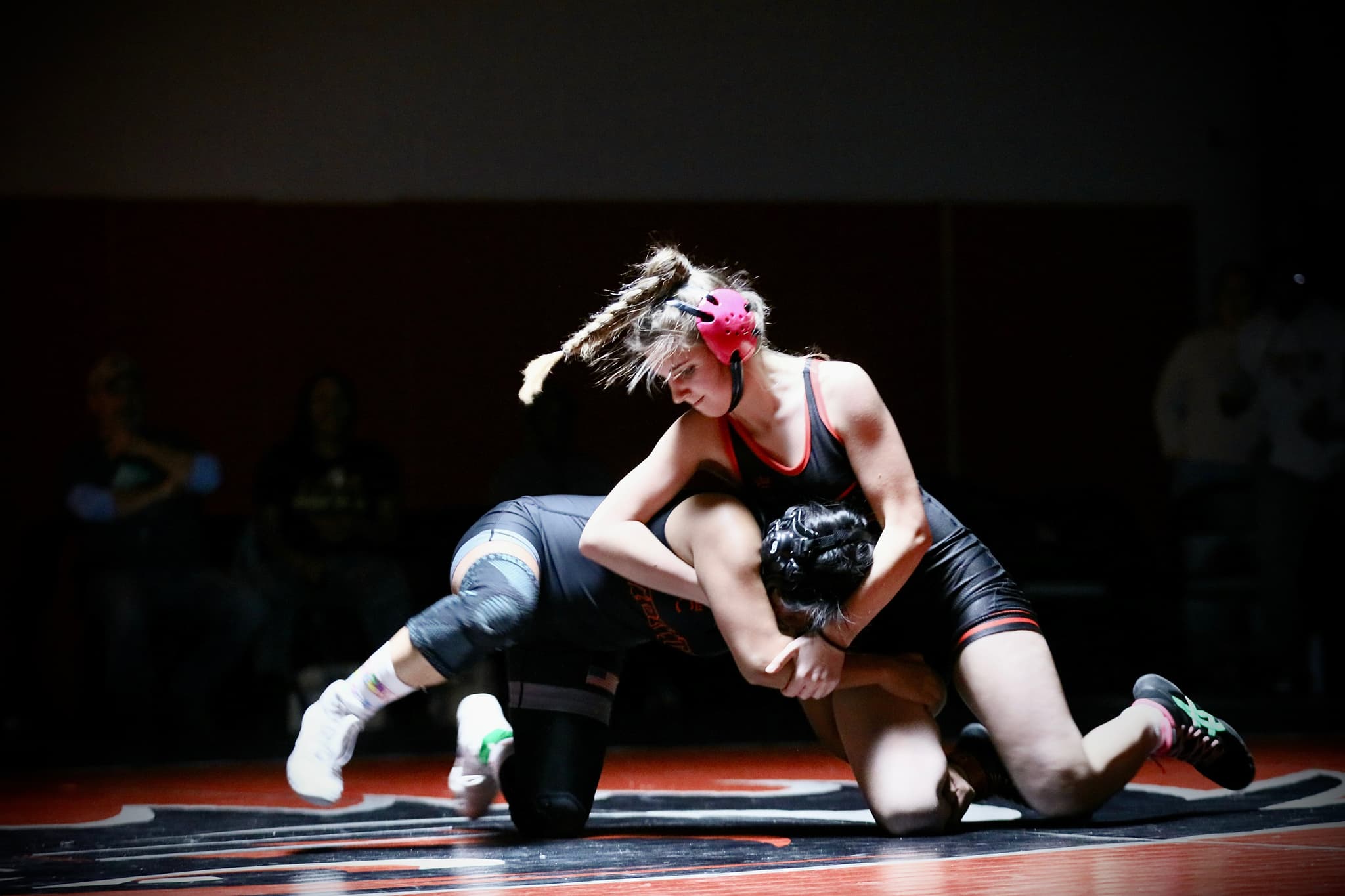 Two wrestlers in a clinch on the mat